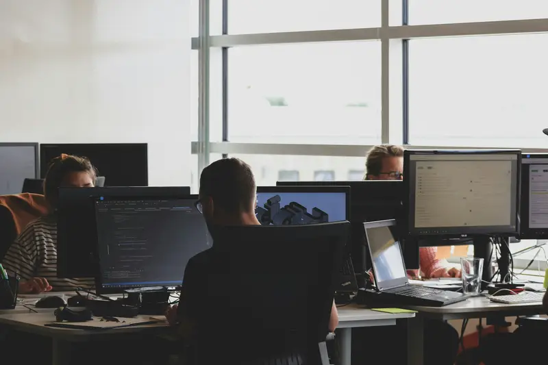 Operations team working at computer screens in an office
